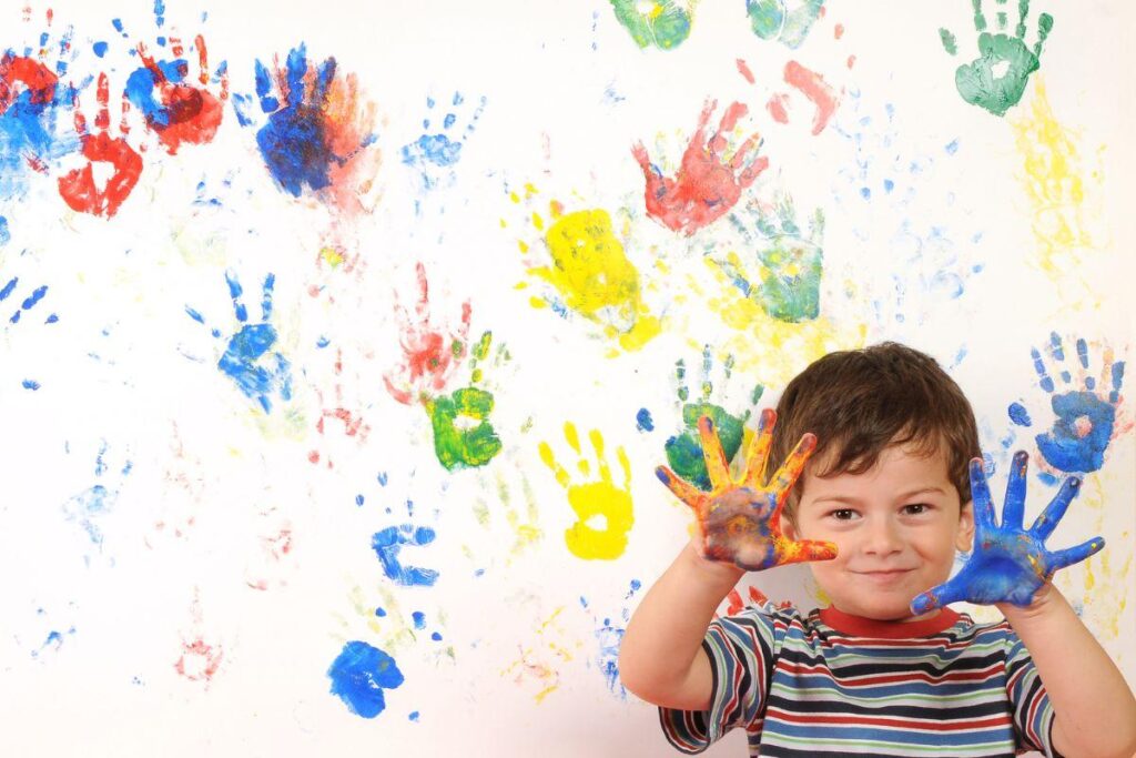 finger painting with boy